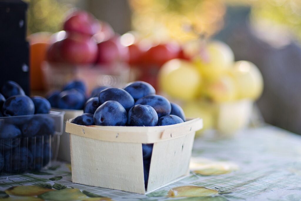 Basket of Plums at Farmers Market