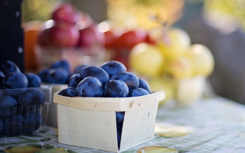 Basket of Plums at Farmers Market